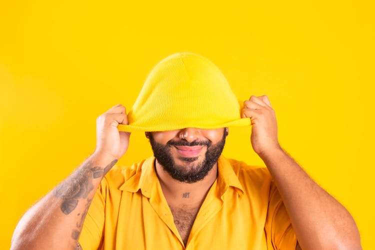 Bearded Man In Yellow Clothes On Yellow Studio Background