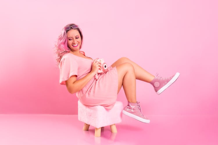 Smiling Woman In Pink Clothes Posing In Pink Studio