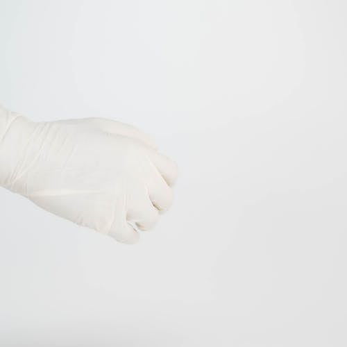 Studio Shoot of a White Plastic Glove against White Background