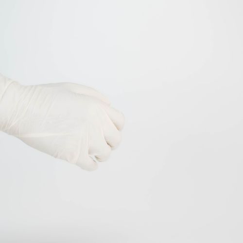 Free Detailed image of a hand wearing a white surgical glove against a clean, white background with ample copy space. Stock Photo