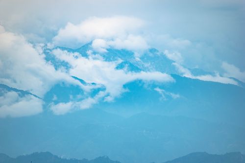 Free A scenic view of mountains shrouded in clouds, showcasing a serene and picturesque landscape. Stock Photo