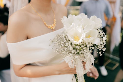 Close-up of a Person Holding White Flowers