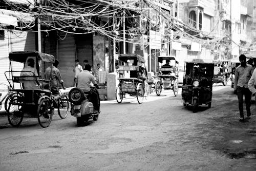 Black and White Photo of Carts and Pedestrians on a Busy Street