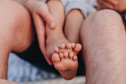 Free Person Holding Baby's Foot Stock Photo