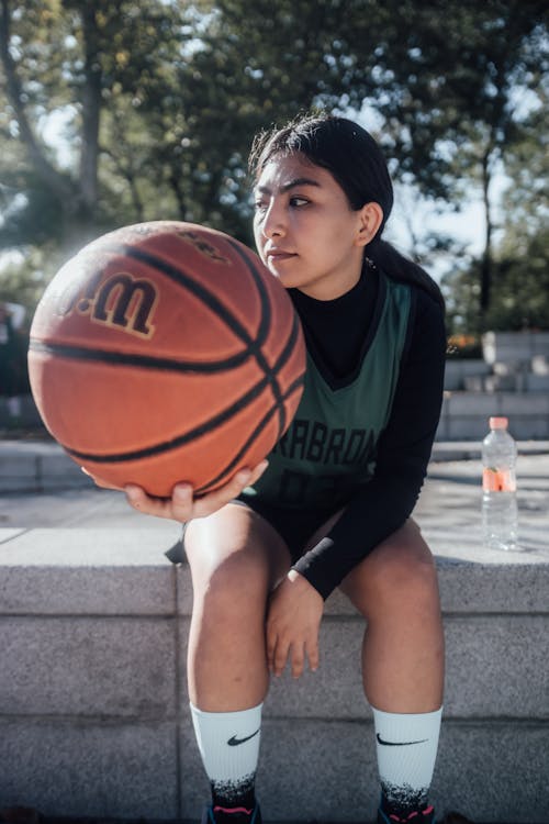 Woman Holding a Basketball