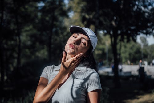 Young Woman Facing the Sun with Eyes Closed 