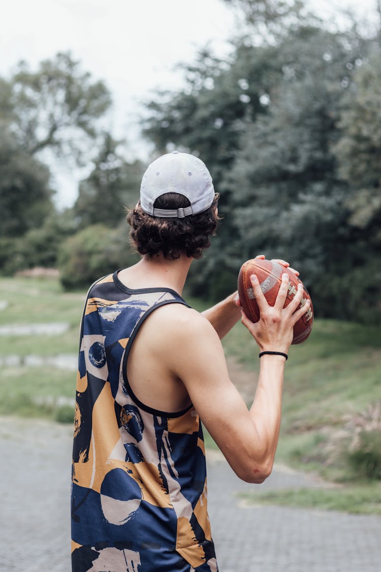 Back View Of Man Throwing A Football Ball 