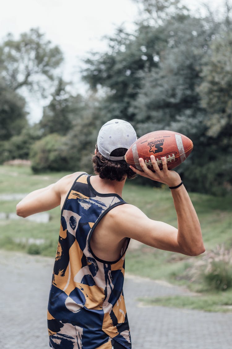 Back View Of Man Throwing A Football Ball 