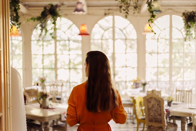 Back View Of A Woman Entering A Restaurant