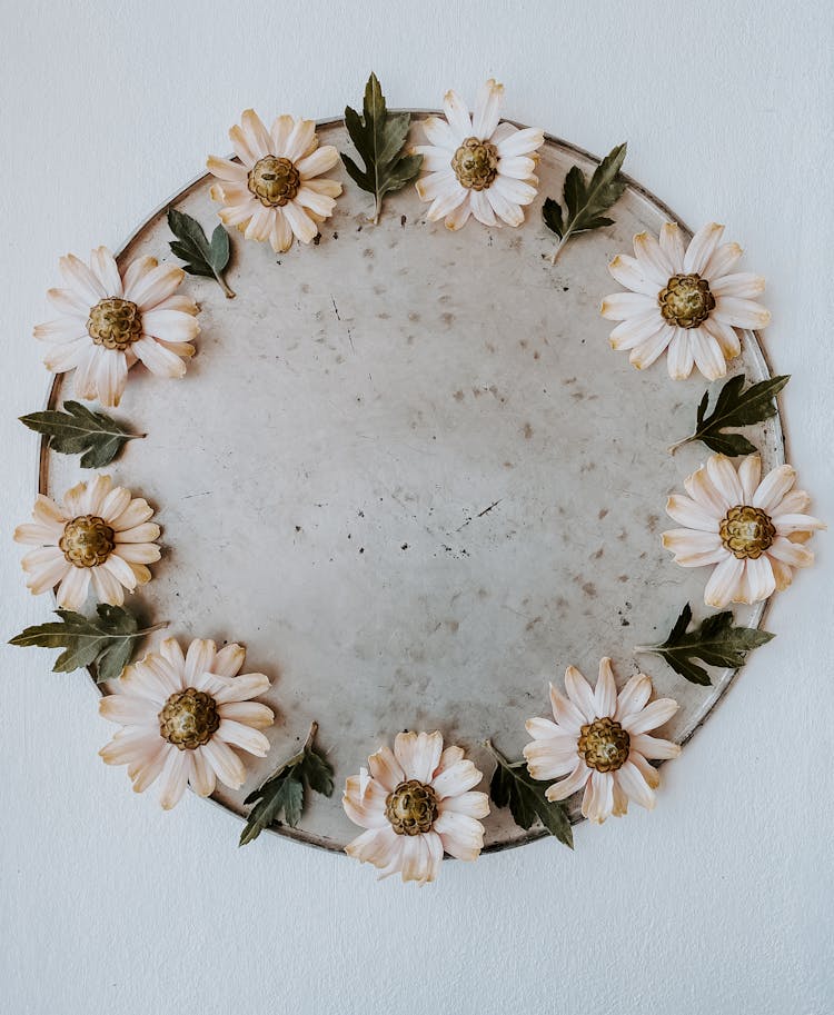 White Flowers And Leaves On A Round Tray