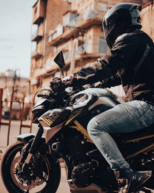Person in Helmet Sitting on Motorcycle 