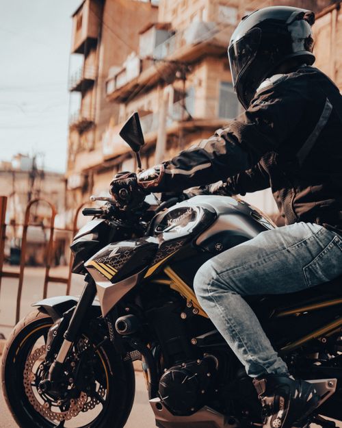 Free A motorcyclist dressed in protective gear rides a motorbike in urban Jodhpur, India. Stock Photo