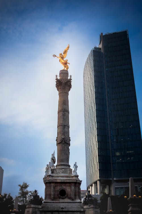 A Low Angle Shot of The Angel of Independence Near the Building