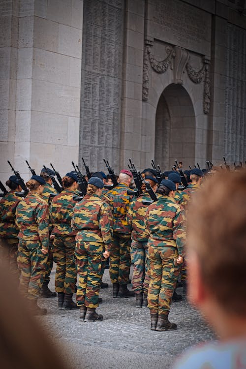 Soldiers in Camouflage Uniforms Holding Rifles on a Parade in City 