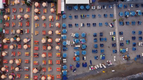Free Drone shot of vibrant beach scene in Borghetto Santo Spirito, Italy. Stock Photo
