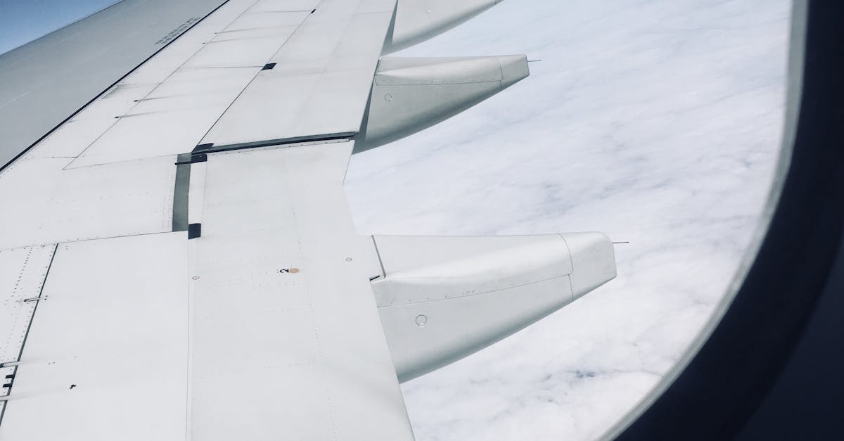 Photo by ZA Sonder A high-altitude view from an airplane window capturing the wing against a clear sky.