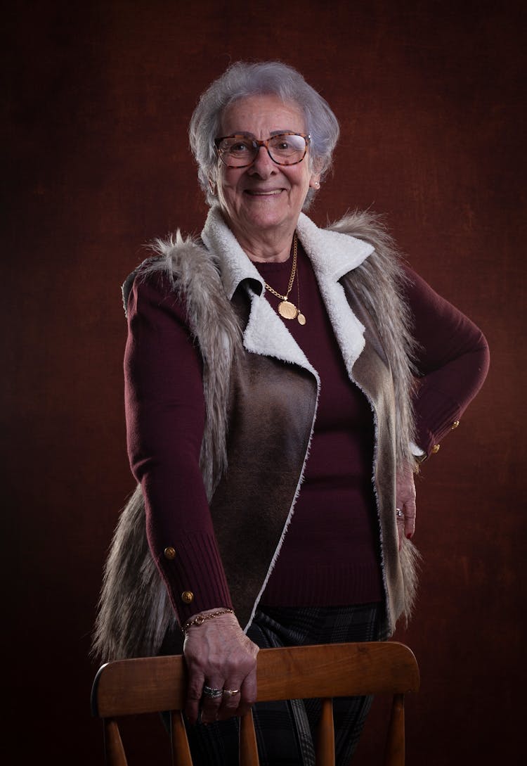 Smiling Old Woman In Glasses Posing In Studio