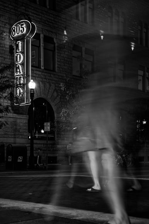 Grayscale Photography of People Walking on the Street Near Business Establishment