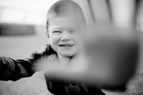 Grayscale Photo of a Kid