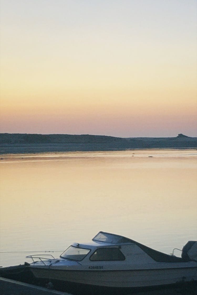 White Speedboat Docked On A Lake