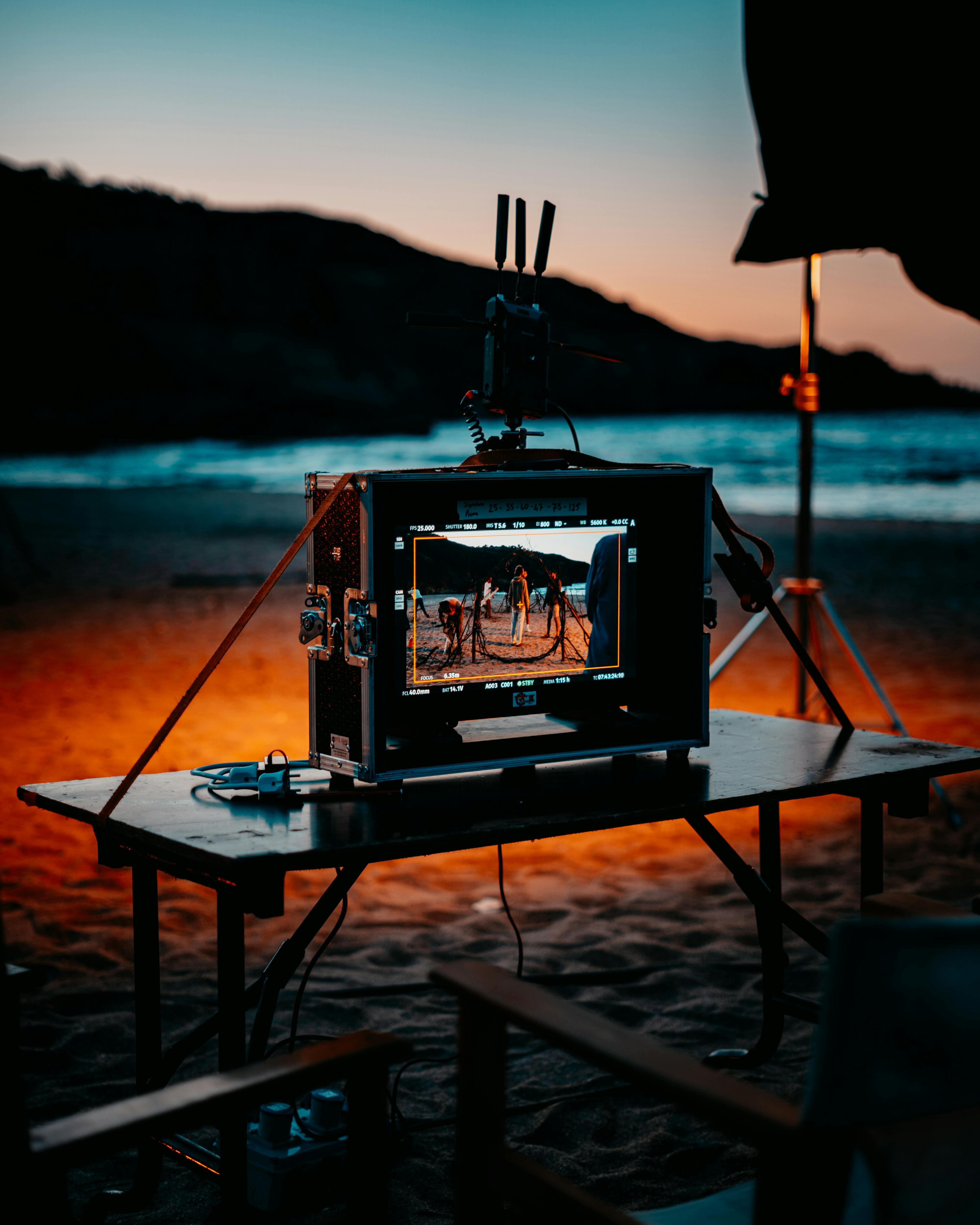 people on beach on screen on suitcase