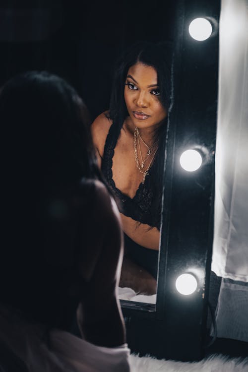 Woman Standing in Front of a Mirror