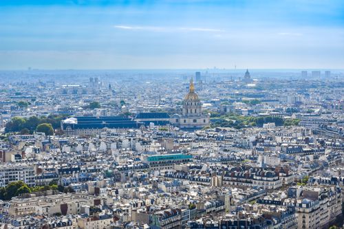 Free A breathtaking aerial shot of Paris featuring iconic landmarks under a vibrant sky. Stock Photo