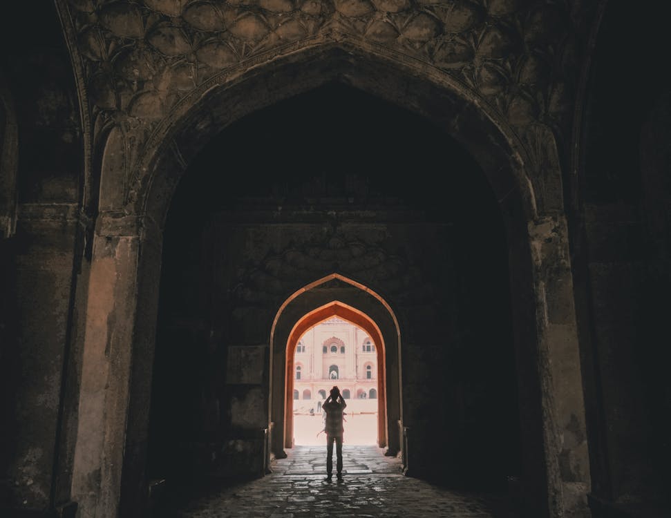 Man Standing Between Buildings