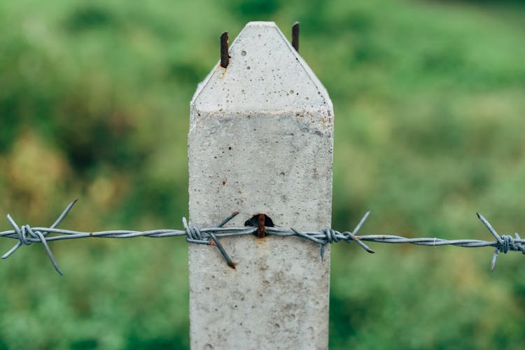 Barbed Wire On Stone Post