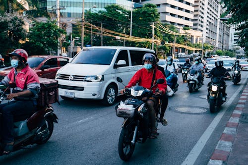 Bikers Waiting in Traffic on Street