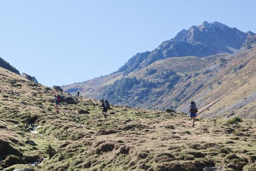 A group of hikers traversing the picturesque landscape of the Pyrenees in Barèges, Occitanie.