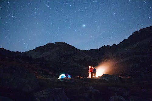 Free A Starry Night Sky over a Campsite Stock Photo