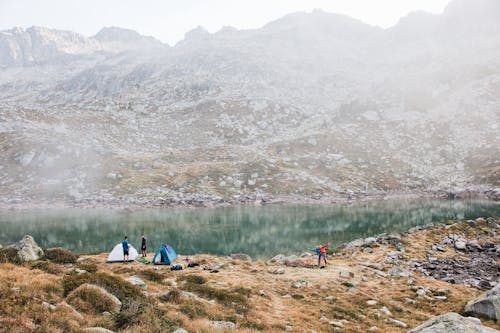 People and Tents Near a Lake 