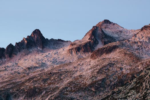 Breathtaking sunrise over Barèges mountain range, showcasing rugged peaks and serene beauty.