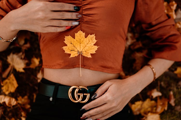 Close-up Of Woman Lying In Autumn Leaves