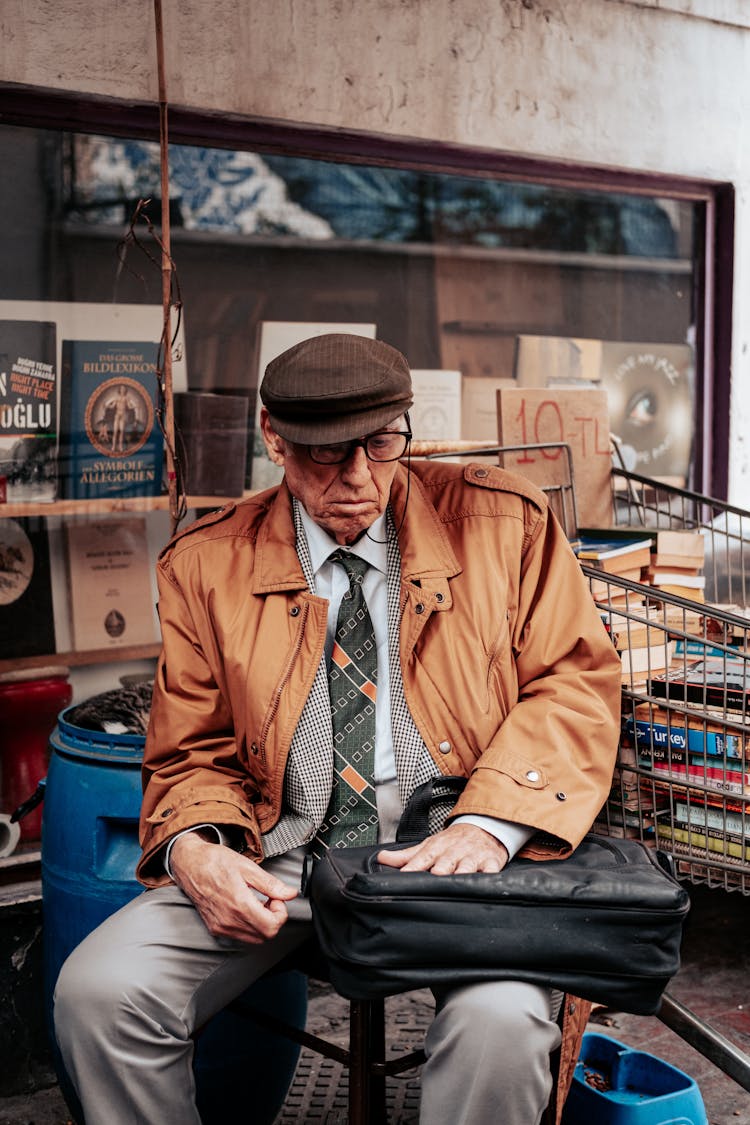 Old Man Sitting In Bookshop