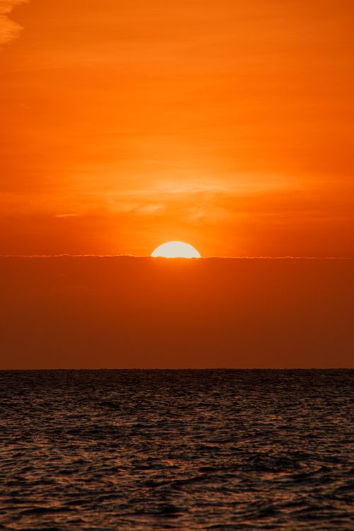 Free Capture of a vibrant sunset over the ocean in Cartagena, Colombia, with rich orange hues. Stock Photo