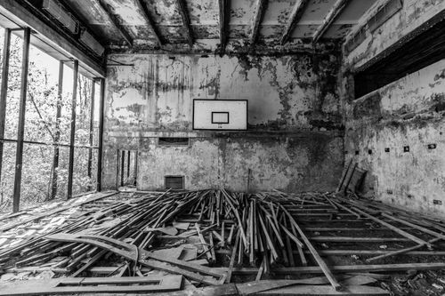 Free Haunting black and white photo of an abandoned basketball court in Chernobyl. Stock Photo