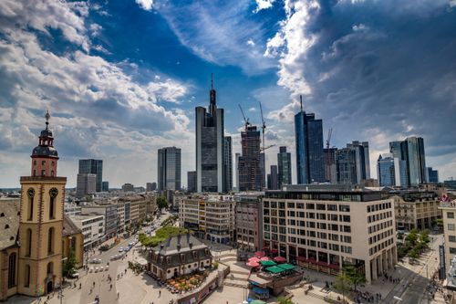 Free A stunning aerial view captures the modern skyline of Frankfurt, showcasing skyscrapers under a dramatic sky. Stock Photo