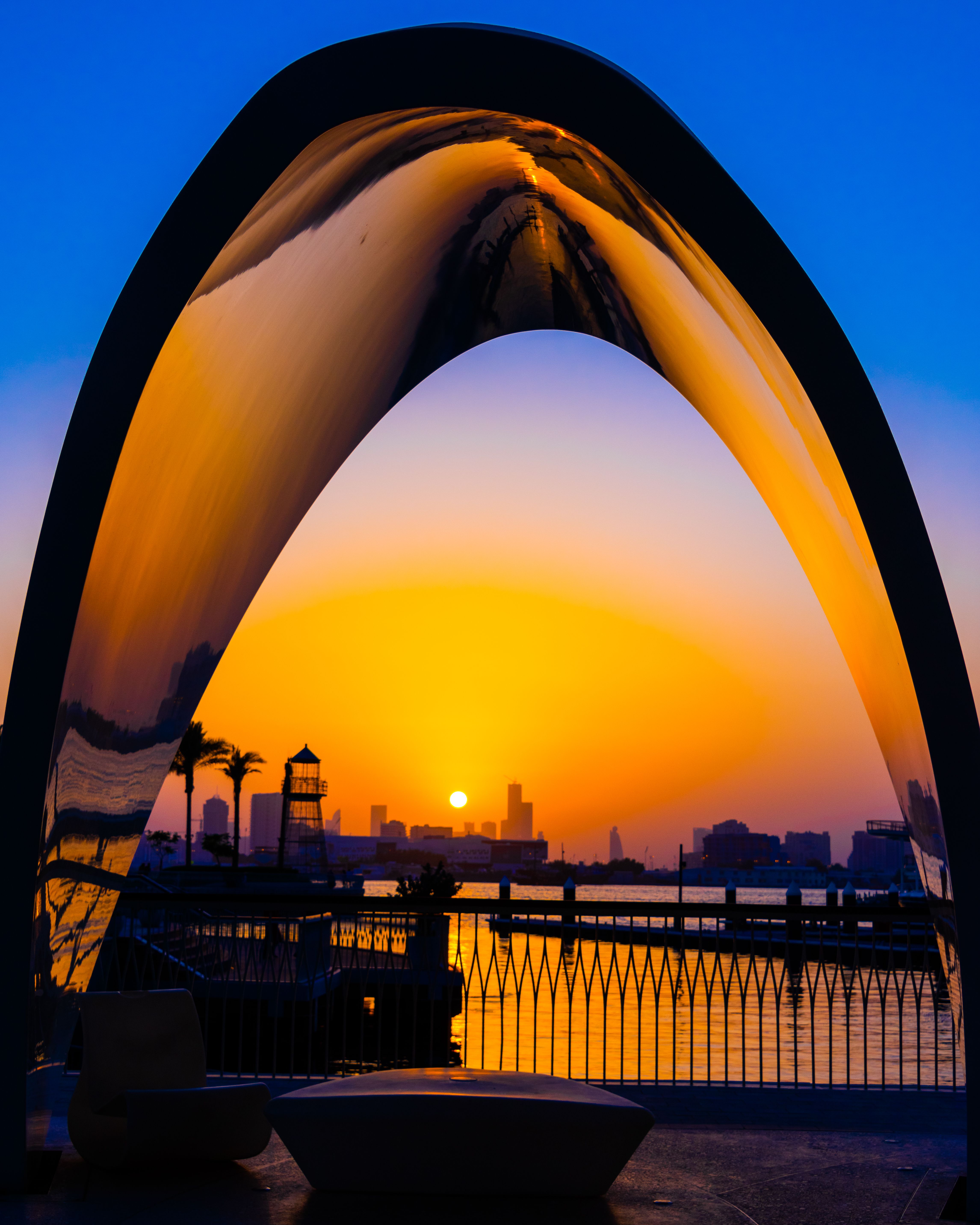 Sunset behind Modern Construction near Water in City · Free Stock Photo
