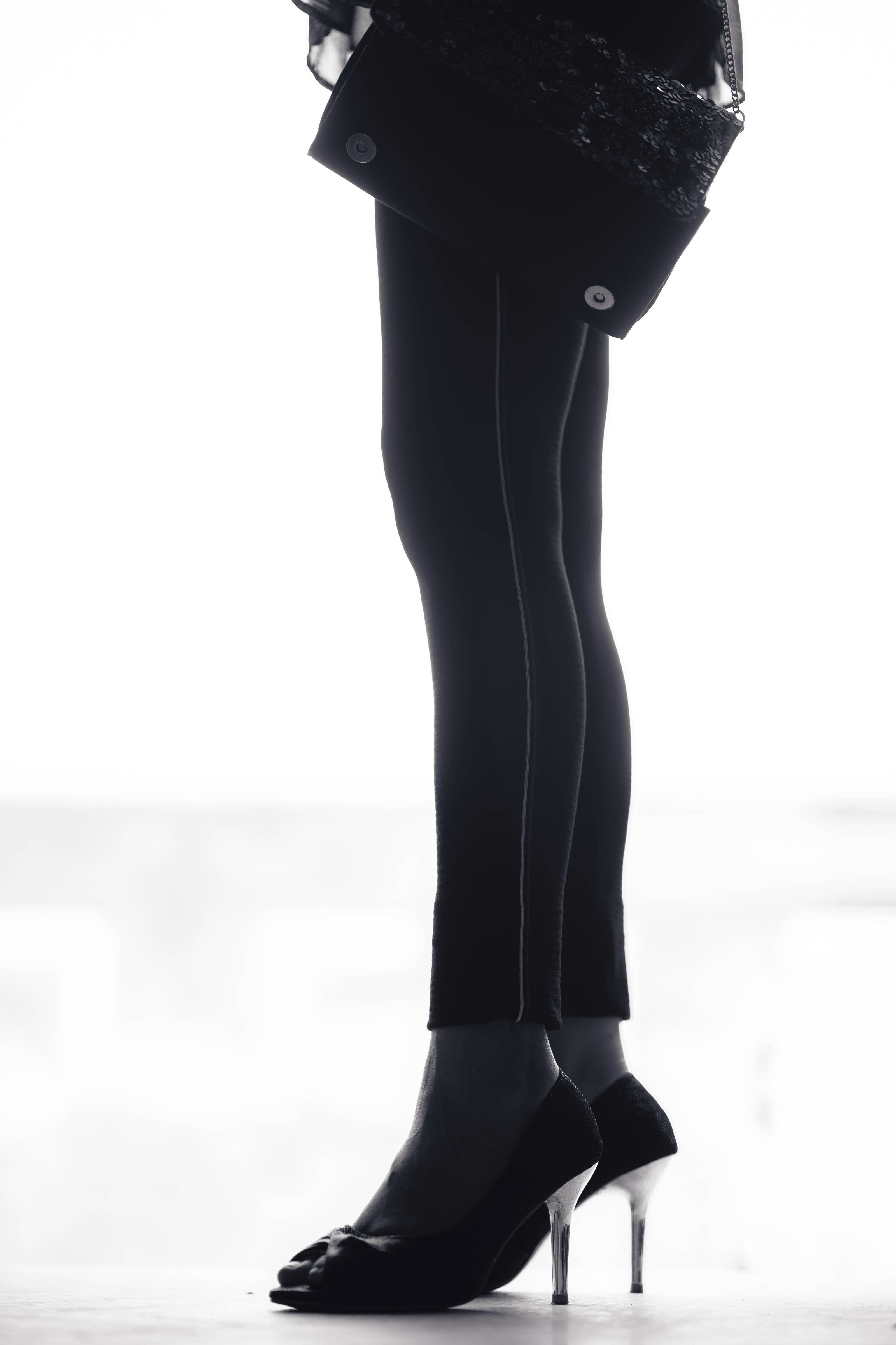 Leggings pretas elegantes e saltos, uma declaração de moda monocromática moderna.