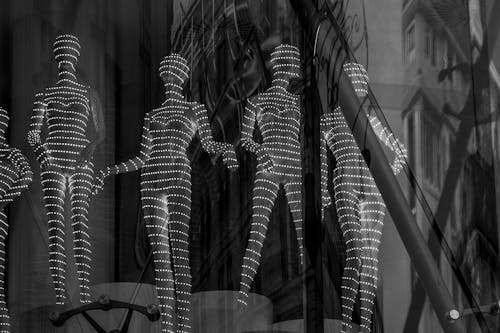 Grayscale Photograph of Mannequins with Lights