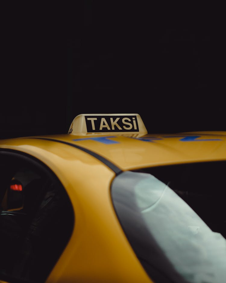 A Taxi Sign On A Car