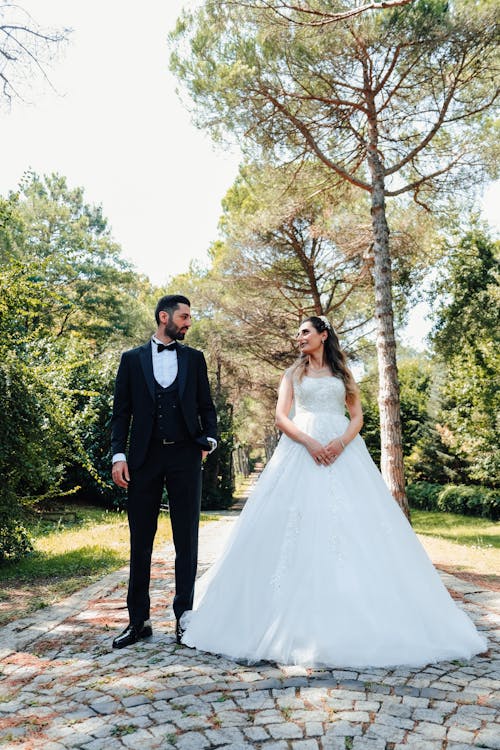 A Man in a Suit and a Woman in a Gown Looking at Each Other