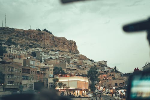 Free Buildings in Town under Hill with Rock Stock Photo