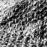 A detailed, black-and-white macro photograph highlighting the repeating circular texture of bubble wrap.