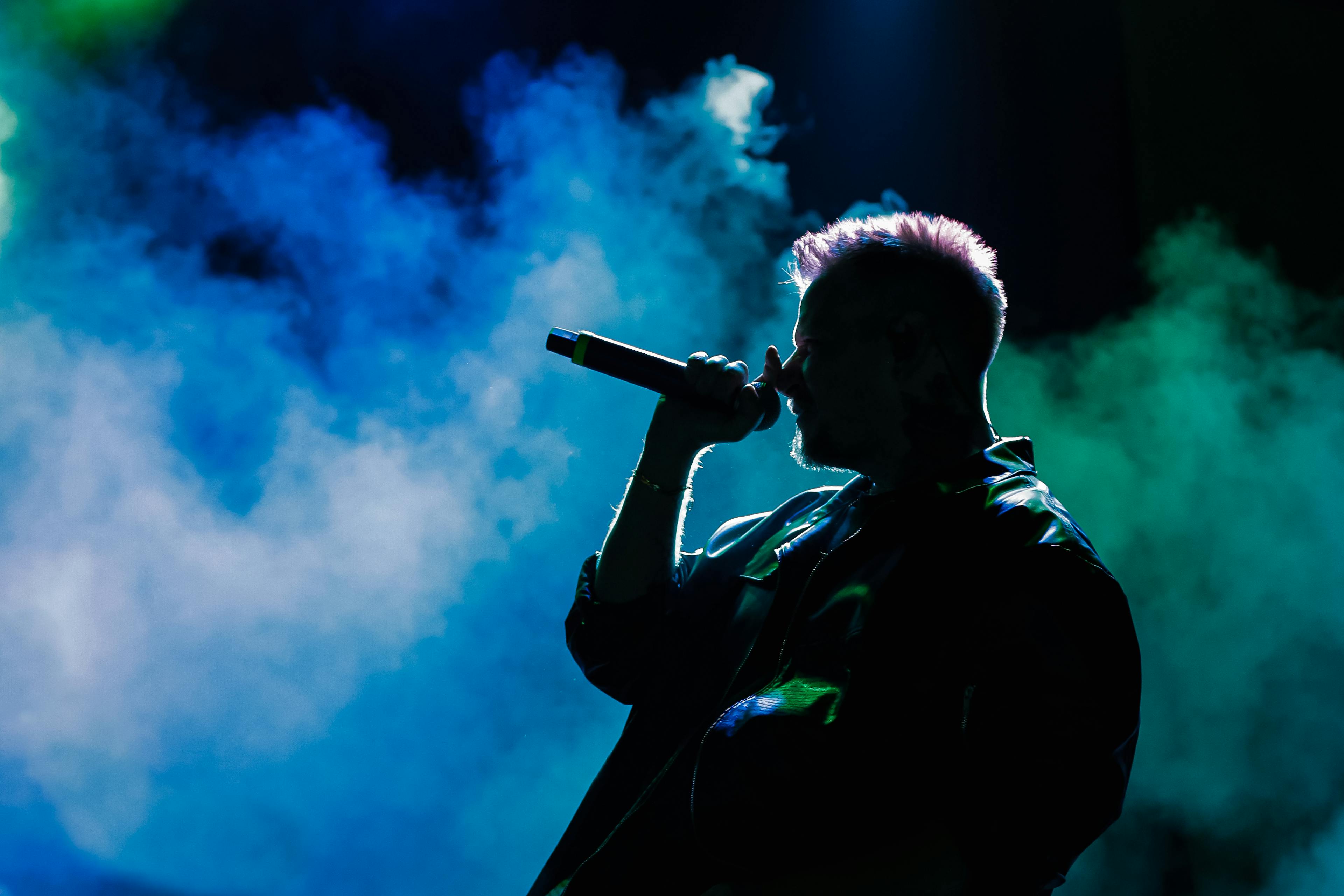 A Man Singing while Holding a Microphone