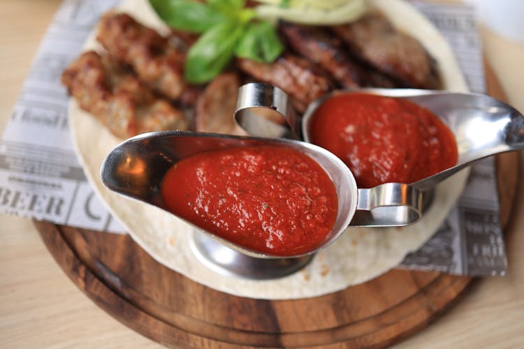 Red Sauce On Stainless Steel Gravy Boats