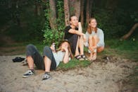 Three Women Relaxing Infront of Trees
