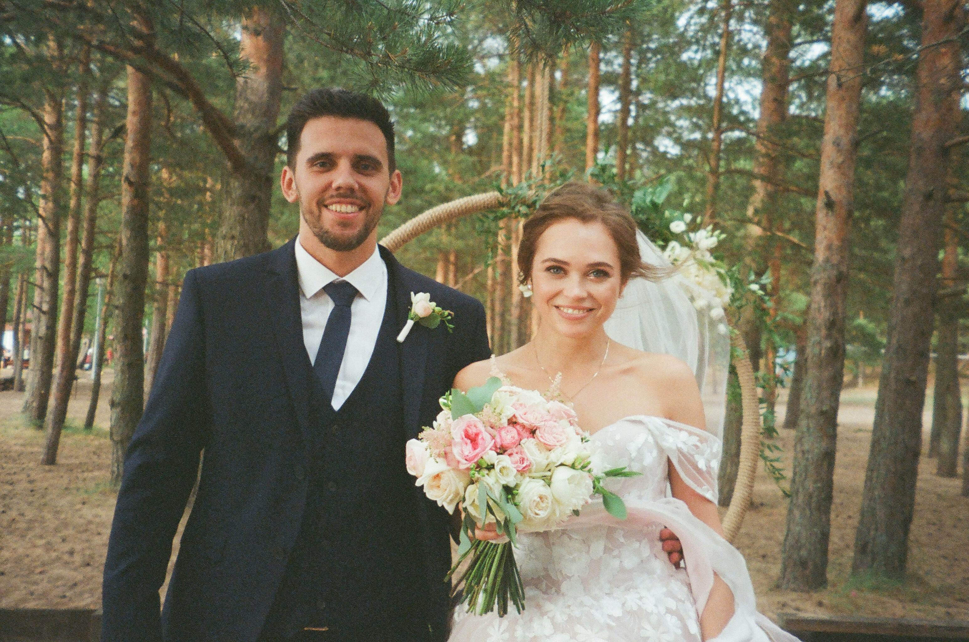 Woman Wearing Pink Wedding Gown Standing Next to Man 